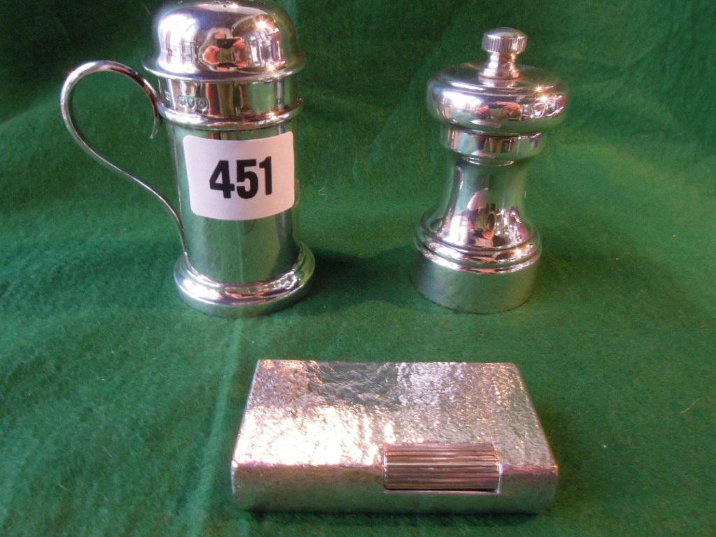 Appraisal: A silver peppermill and a silver salt with loop handle