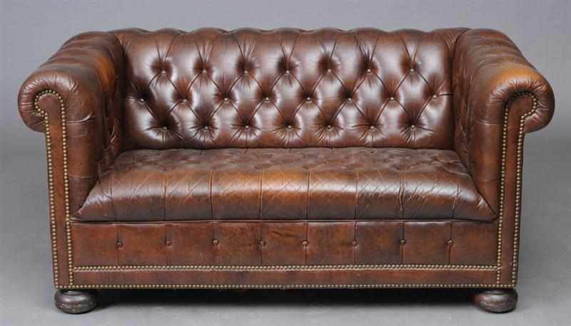 Appraisal: ENGLISH BUTTONED BROWN LEATHER CHESTERFIELD SOFA On bun feet in