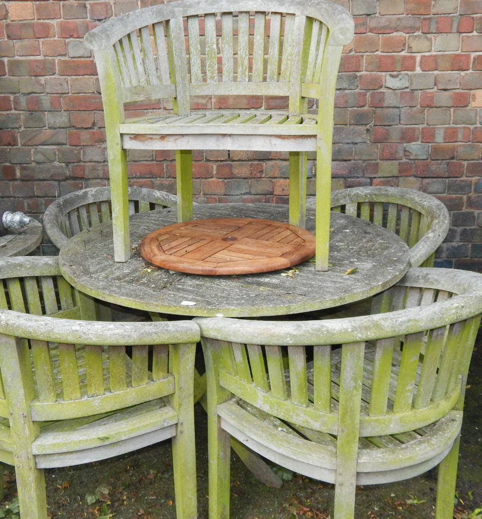 Appraisal: A circular garden table and four tub chairs