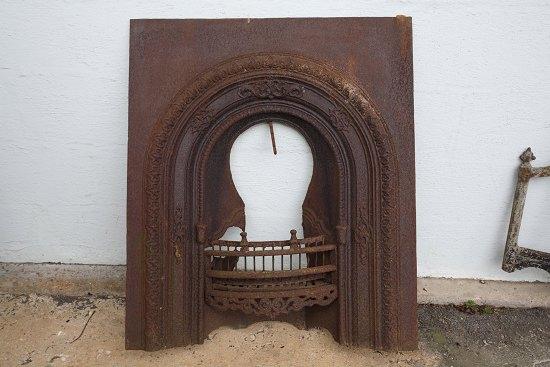 Appraisal: A cast arch top fireplace with embossed decoration cm x