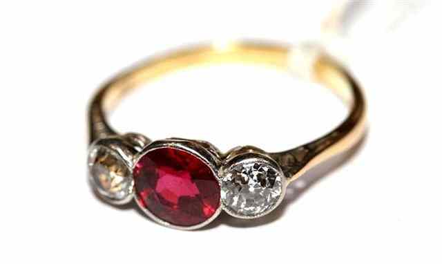 Appraisal: A THREE STONE SPINEL AND DIAMOND SET RING central ruby