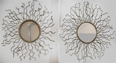 Appraisal: Pair of Gilt-Metal Sunburst Mirrors Estimate -