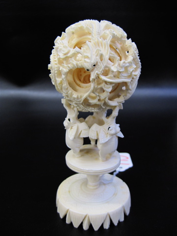 Appraisal: CHINESE IVORY MYSTERY BALL ON DISPLAY STAND the carved ball