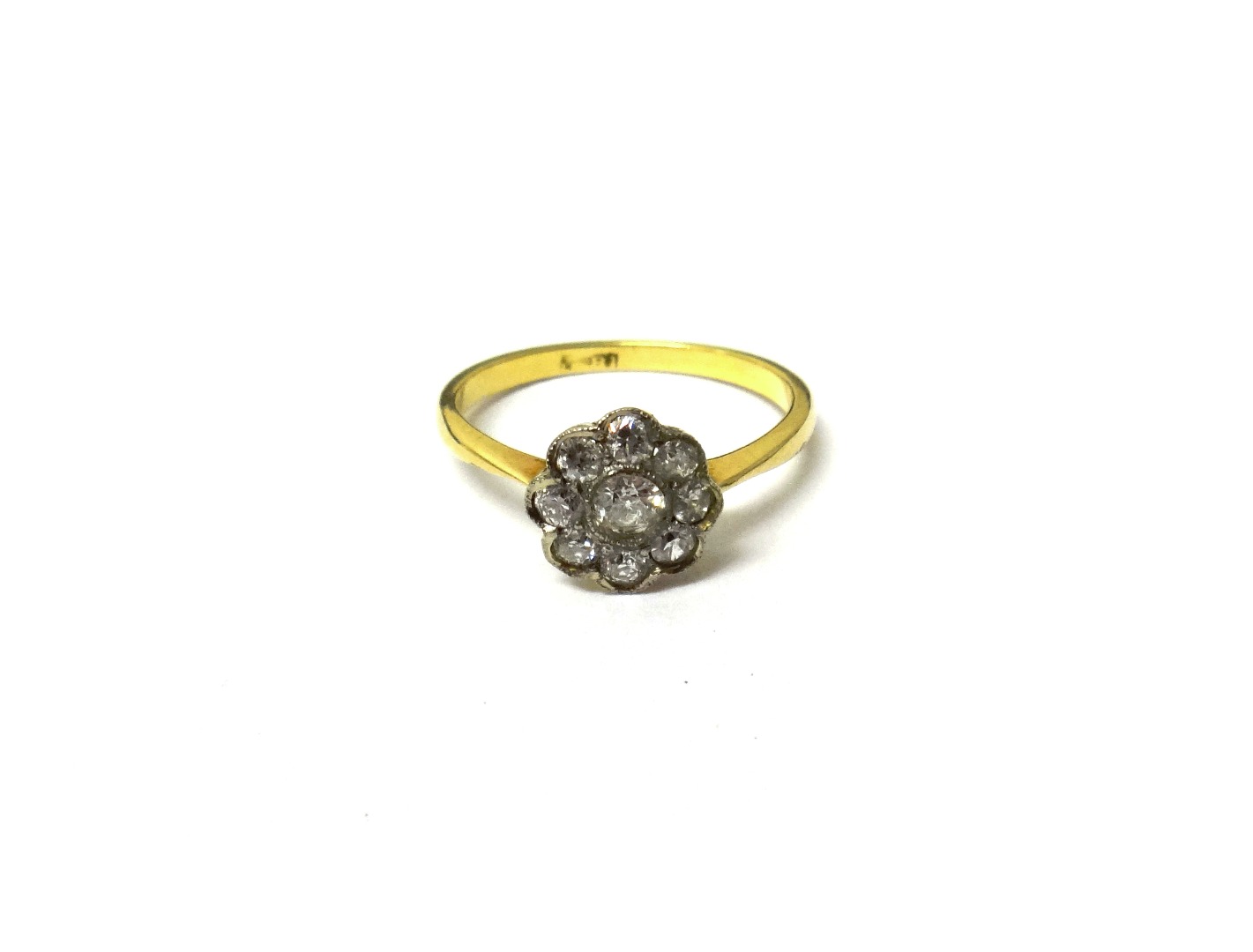 Appraisal: A gold and diamond nine stone cluster ring mounted with