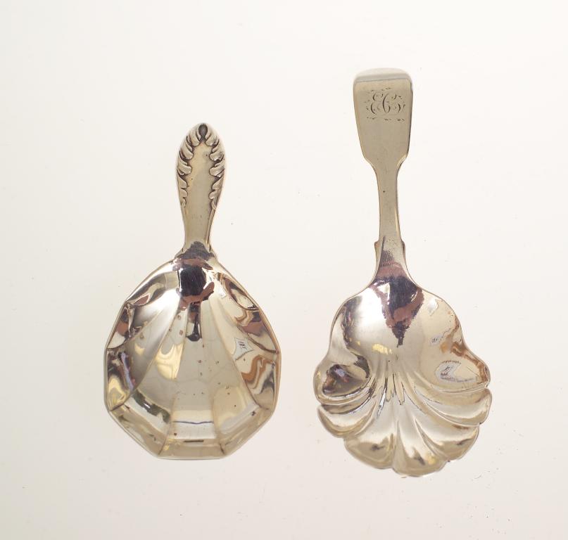 Appraisal: TWO SILVER CADDY SPOONS EXETER AND LONDON the earlier with