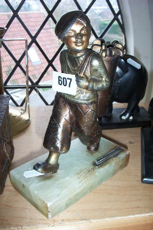 Appraisal: An Art Deco cast metal figure of a boy caddie