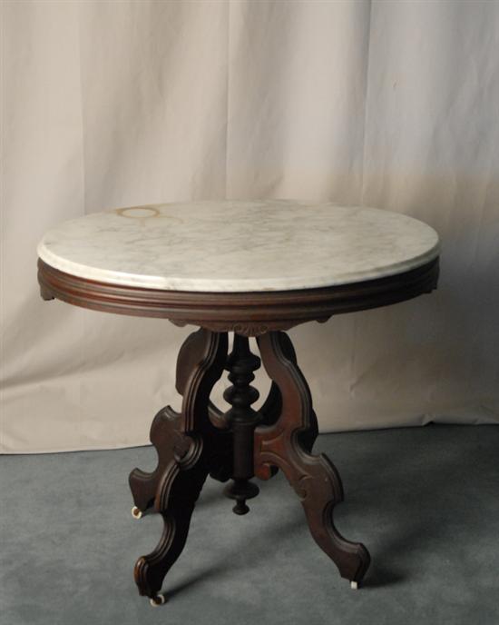 Appraisal: A Victorian Walnut Marble-top Occasional Table having oval white marble