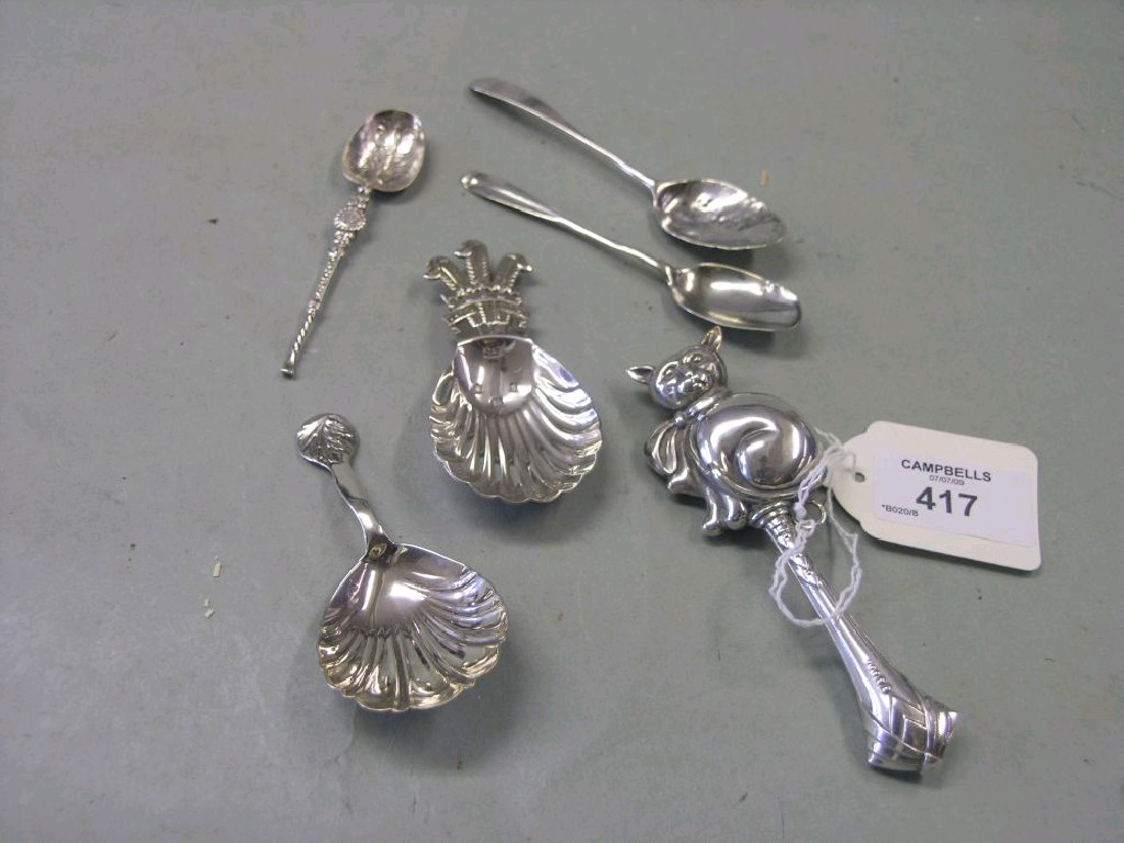 Appraisal: A silver baby rattle in the form of a seated