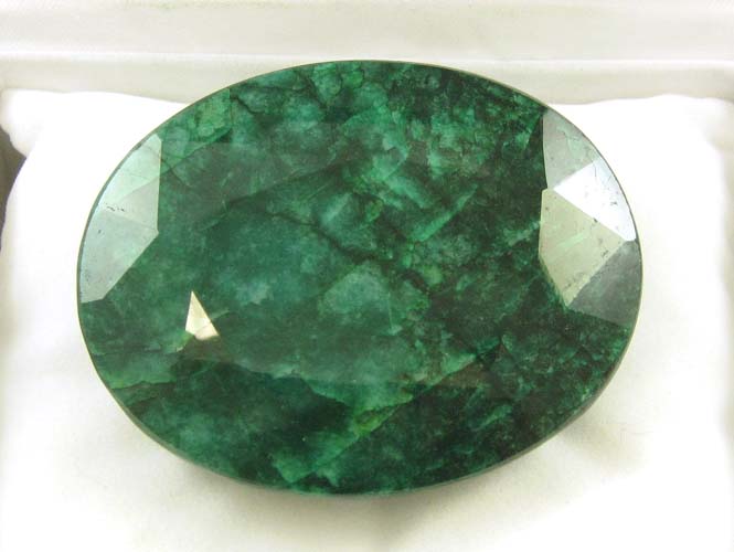 Appraisal: LARGE UNSET EMERALD WITH APPRAISAL The cts oval-cut dark forest