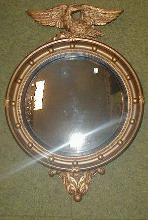 Appraisal: A Regency style circular wall mirror with eagle mount and