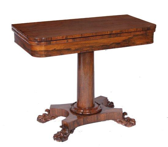 Appraisal: AN EARLY VICTORIAN ROSEWOOD FOLD-OVER CARD TABLE on column supports