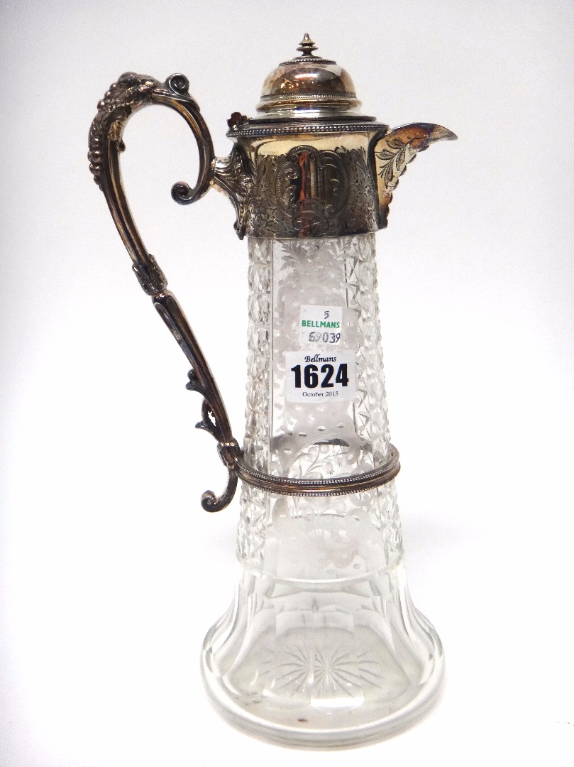 Appraisal: A silver plated metal mounted glass claret jug the body