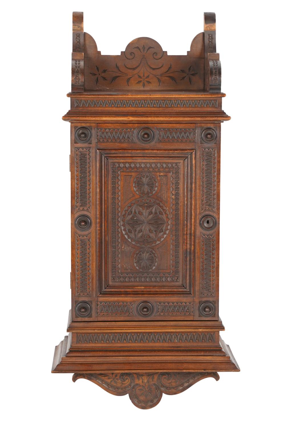 Appraisal: BRITTANY STYLE WALNUT HANGING CUPBOARDthe hinged door enclosing multiple shelves