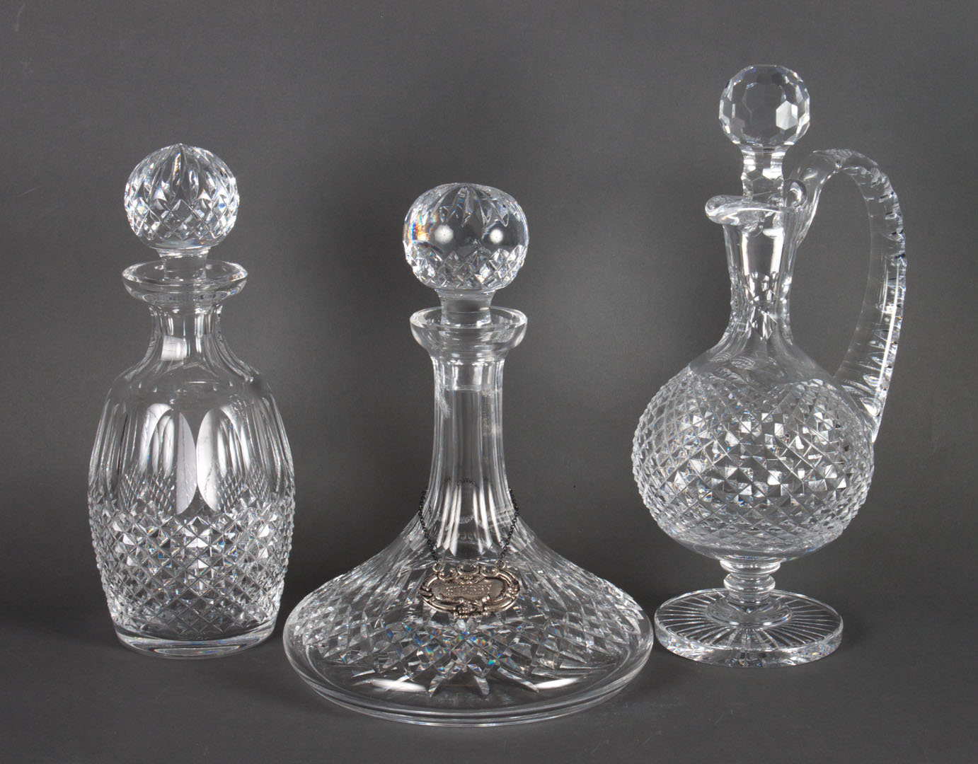 Appraisal: Two Waterford decanters and ewer cap stand decanter with silver