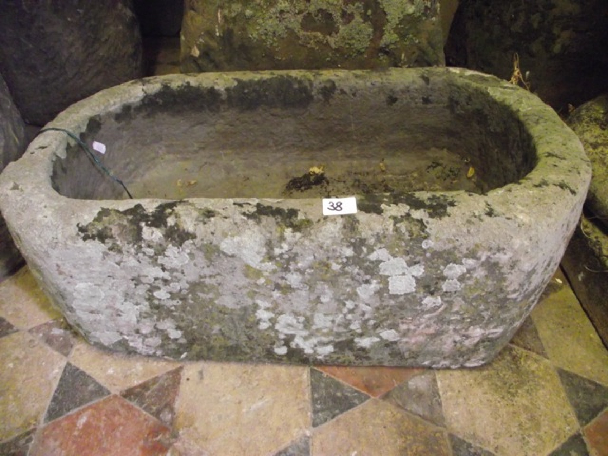 Appraisal: A small weathered natural stone trough of rectangular form with