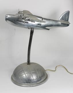 Appraisal: Mid-Century Modern style chrome airplane lamp rising on a globe