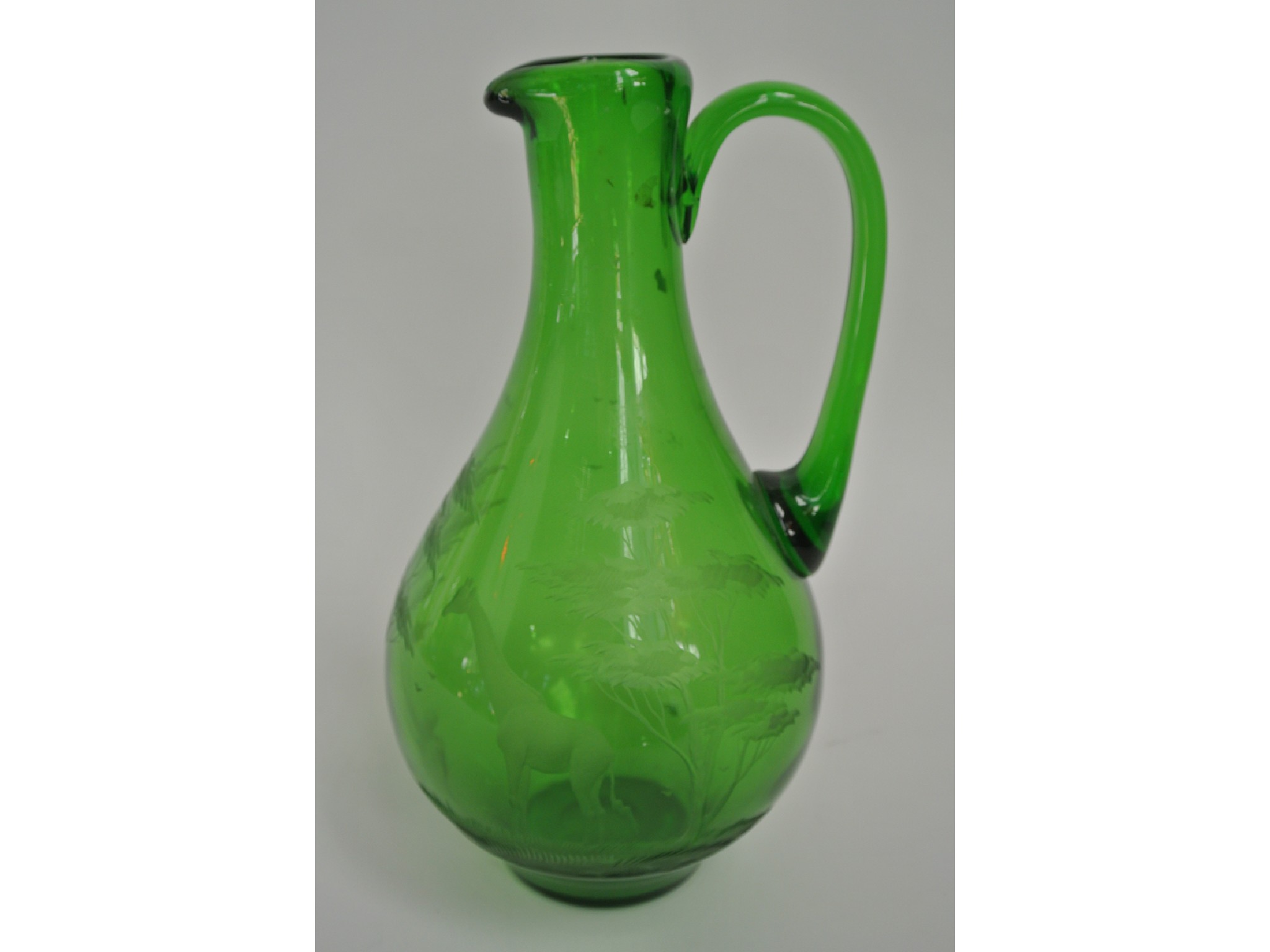 Appraisal: An early th century emerald green glass ewer designed by