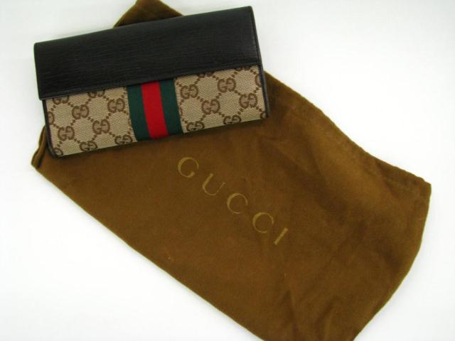 Appraisal: Gucci brown monogram logo bi-fold continental clutch checkbook wallet with