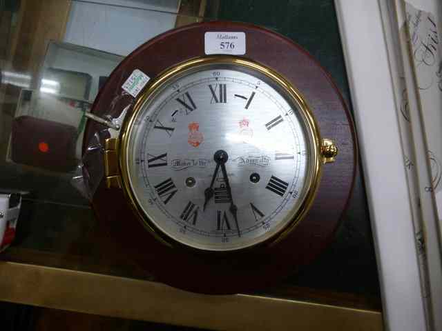 Appraisal: A BRASS CASED MARINE CLOCK with silvered dial by Swells