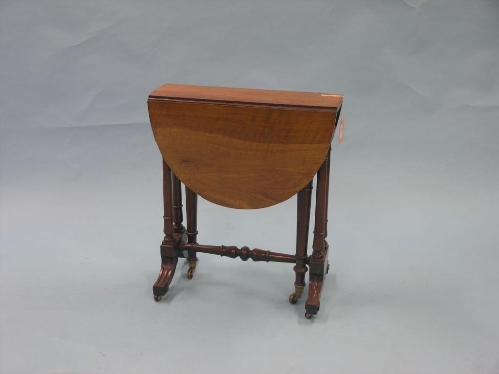 Appraisal: A Victorian walnut Sutherland table on twin-turned end supports with