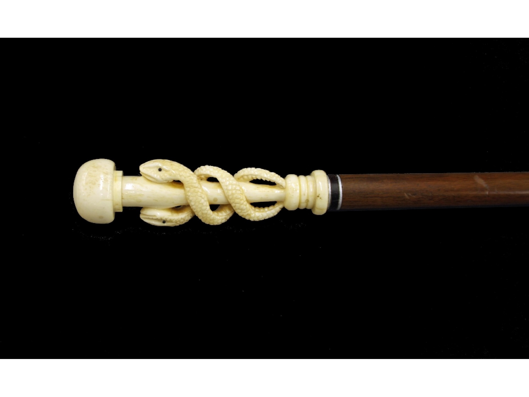 Appraisal: Malacca cane walking stick the bone handle carved with intertwined