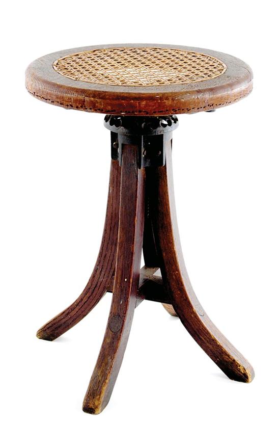 Appraisal: Oak and cane piano stool circular seat with cane panel