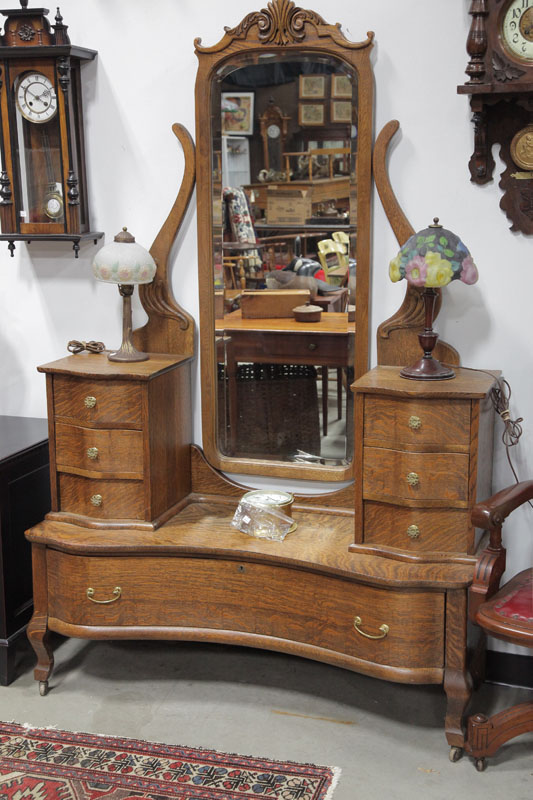 Appraisal: MIRRORED VANITY Oak having a carved mirror flanked by two