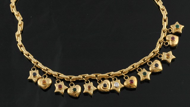 Appraisal: A gold and precious stone set charm necklace Comprising star