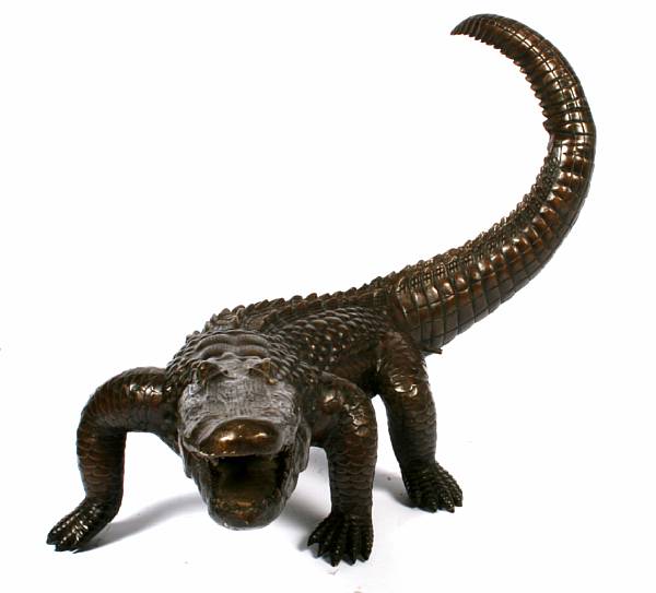 Appraisal: A patinated bronze figure of a crocodile fitted as a