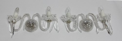 Appraisal: Four two-branch two-light wall lights with scroll branches hung elongated