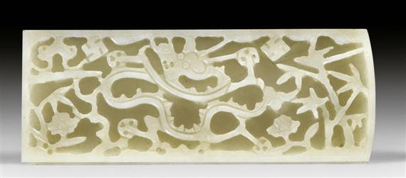 Appraisal: A PALE CELADON JADE PLAQUE CARVED WITH A DRAGON AND