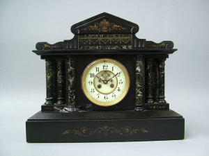 Appraisal: A slate cased mantel clock of architectural form circa the