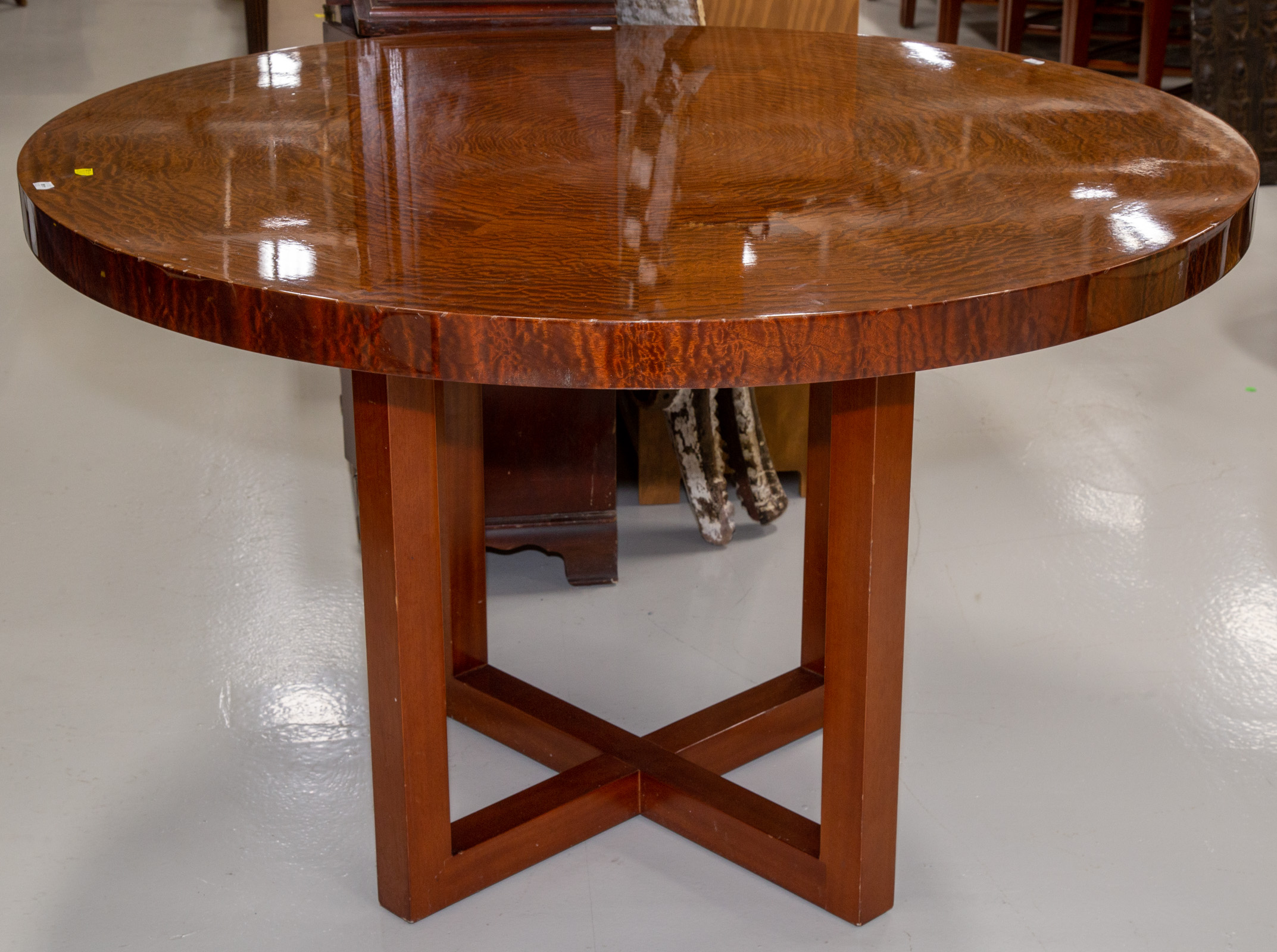 Appraisal: A MODERN ROUND MAHOGANY CENTER TABLE With round bookmatch lace