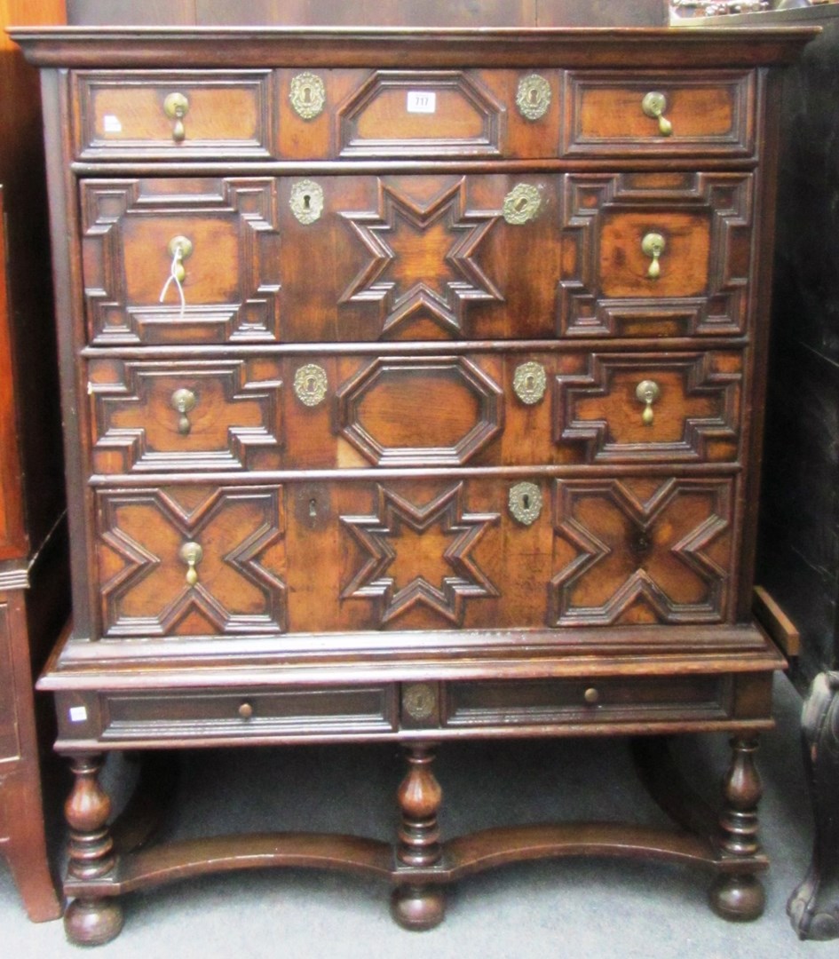 Appraisal: A Charles II style oak four drawer geometric moulded chest