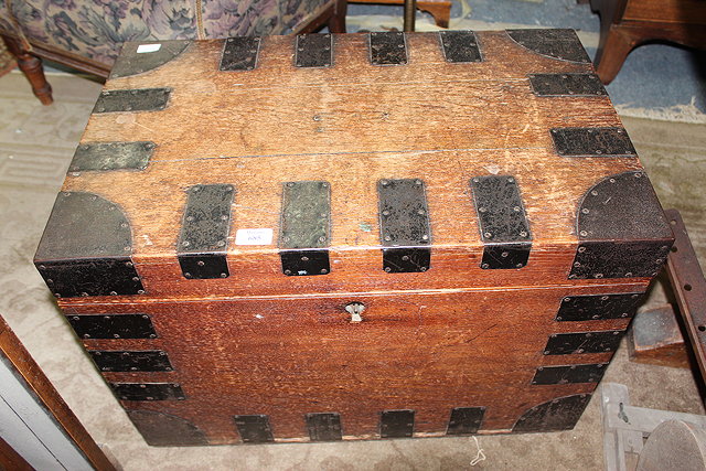 Appraisal: AN OAK IRON BOUND TRUNK with carrying handles to the