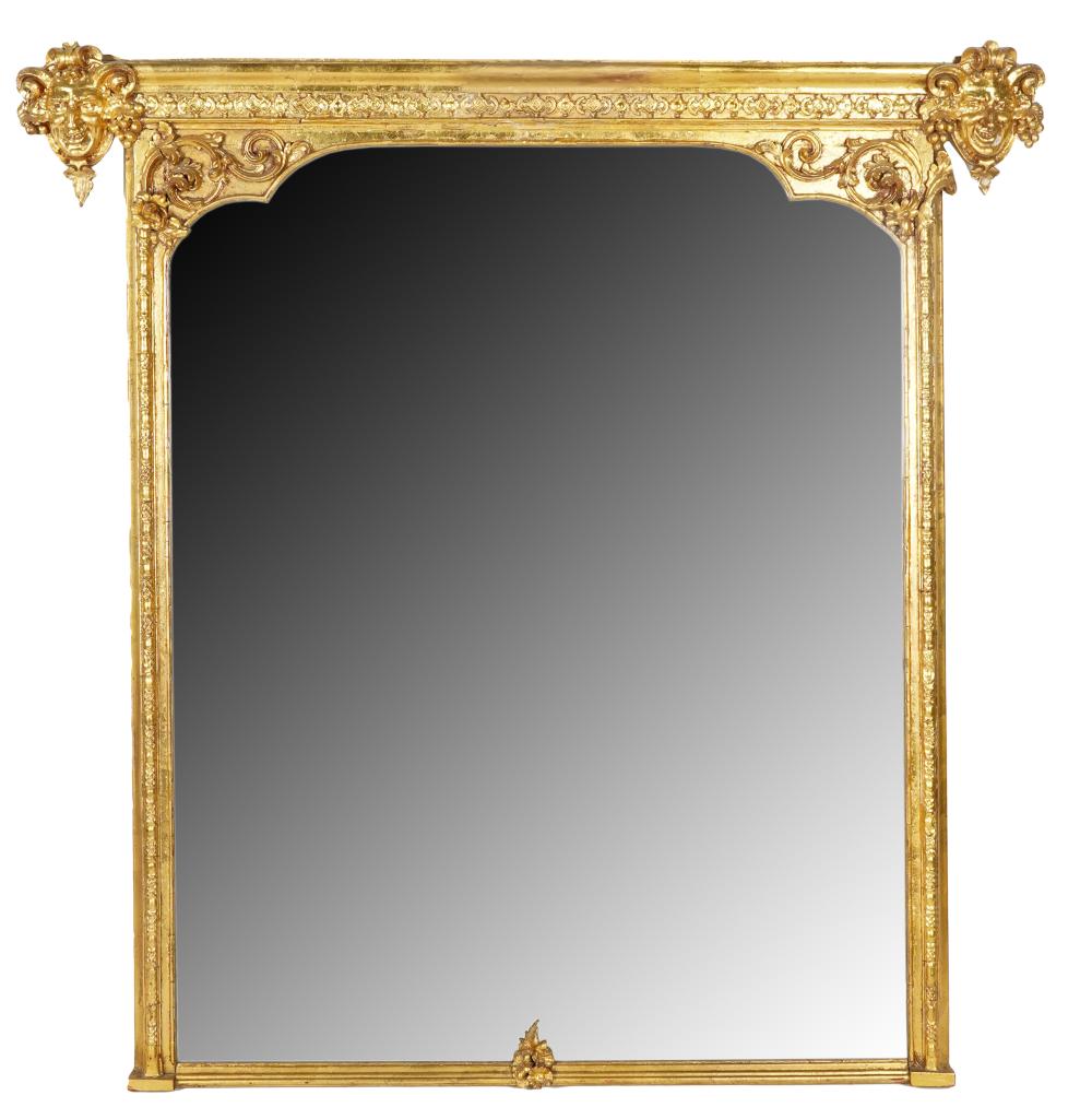 Appraisal: CARVED GILT WOOD WALL MIRRORthe arched flat mirror plate within