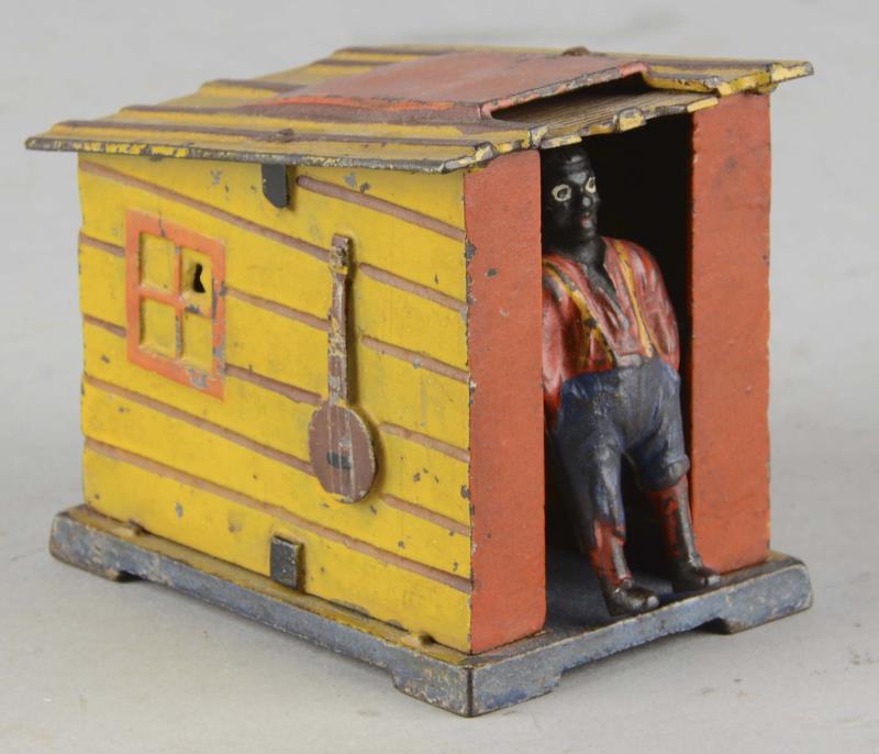 Appraisal: J E Stevens Mechanical Cabin Bank This mechanical bank features