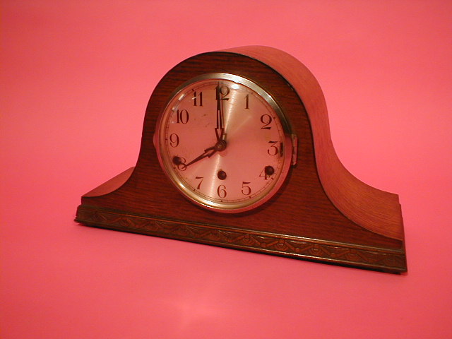 Appraisal: A chiming oak Napoleons hat mantel clock