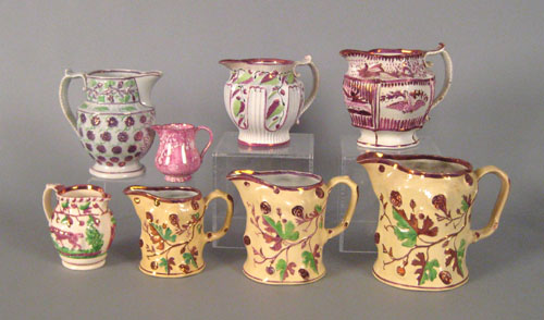 Appraisal: Three graduated pink luster pitchers th c with relief grapevine