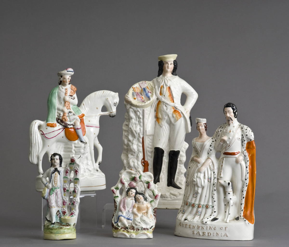 Appraisal: FIVE STAFFORDSHIRE FIGURAL GROUPS INCLUDING A HUNTER WITH GUN Height