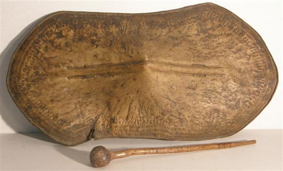 Appraisal: African buffalo hide shield and a wooden club the shield