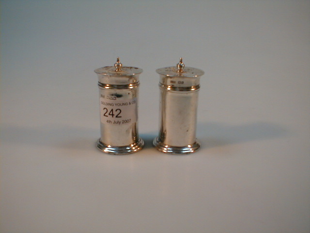 Appraisal: A pair of George V silver cylindrical pepper pots by