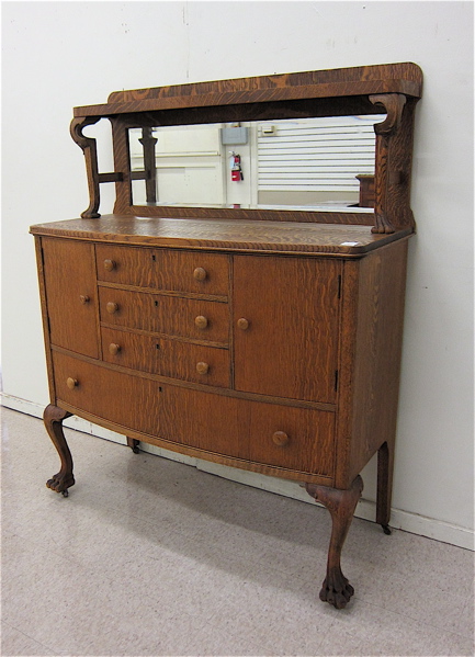 Appraisal: AN OAK BOW-FRONT SIDEBOARD American c having a mirror paneled