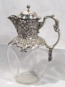 Appraisal: A silver mounted glass claret jug the embossed mounts by