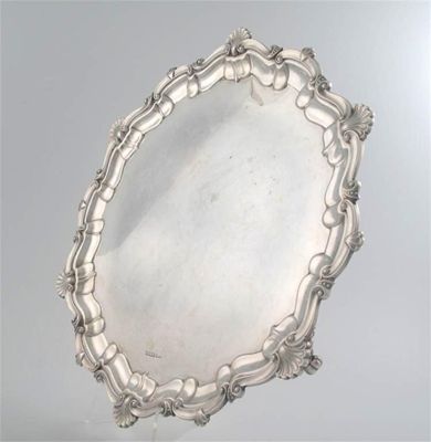 Appraisal: An Edwardian large salver shaped circular outline with a shell