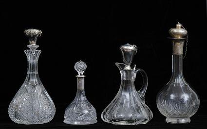 Appraisal: GROUP OF FOUR CUT-GLASS DECANTERS WITH SILVER STOPPERS OR NECKS