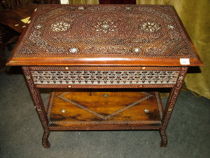 Appraisal: An Egyptian carved table the inlaid carved top upon square