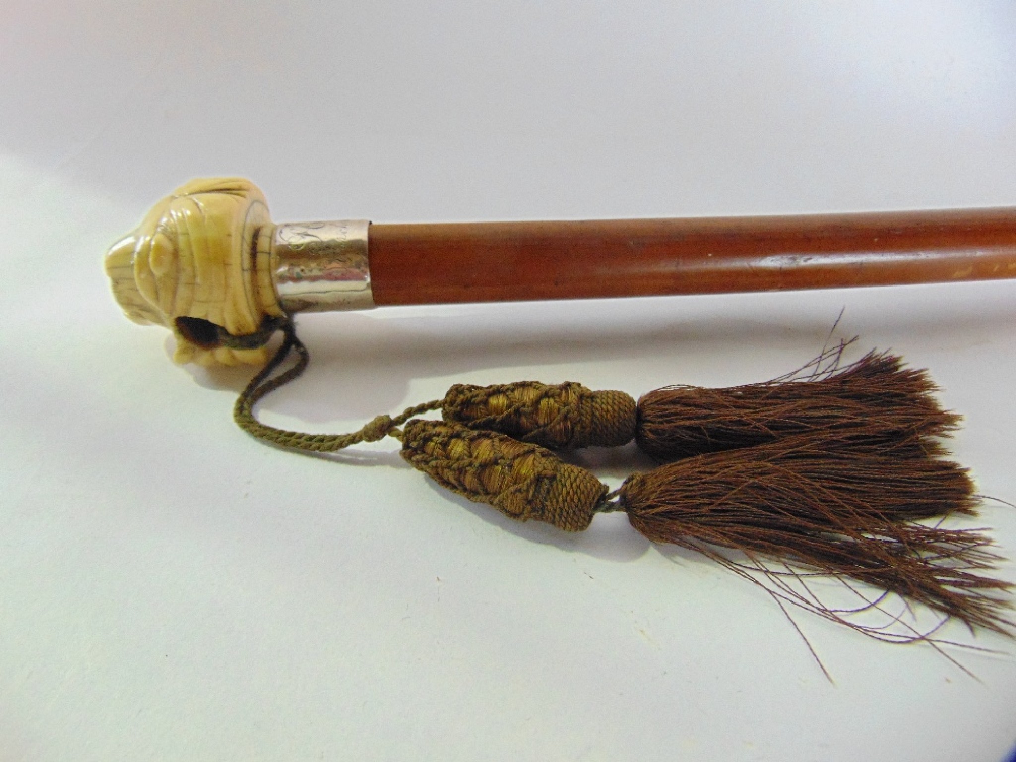 Appraisal: an antique malacca walking cane terminating in an applied worked