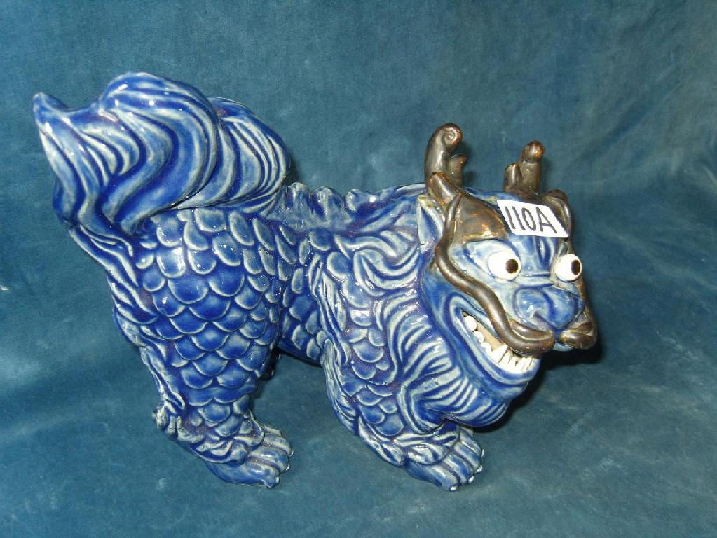 Appraisal: An oriental dark blue glazed dog of fo with open