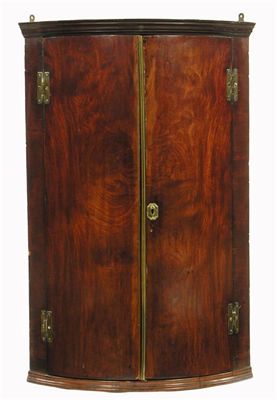 Appraisal: A George III mahogany bowfront hanging corner cupboard the painted